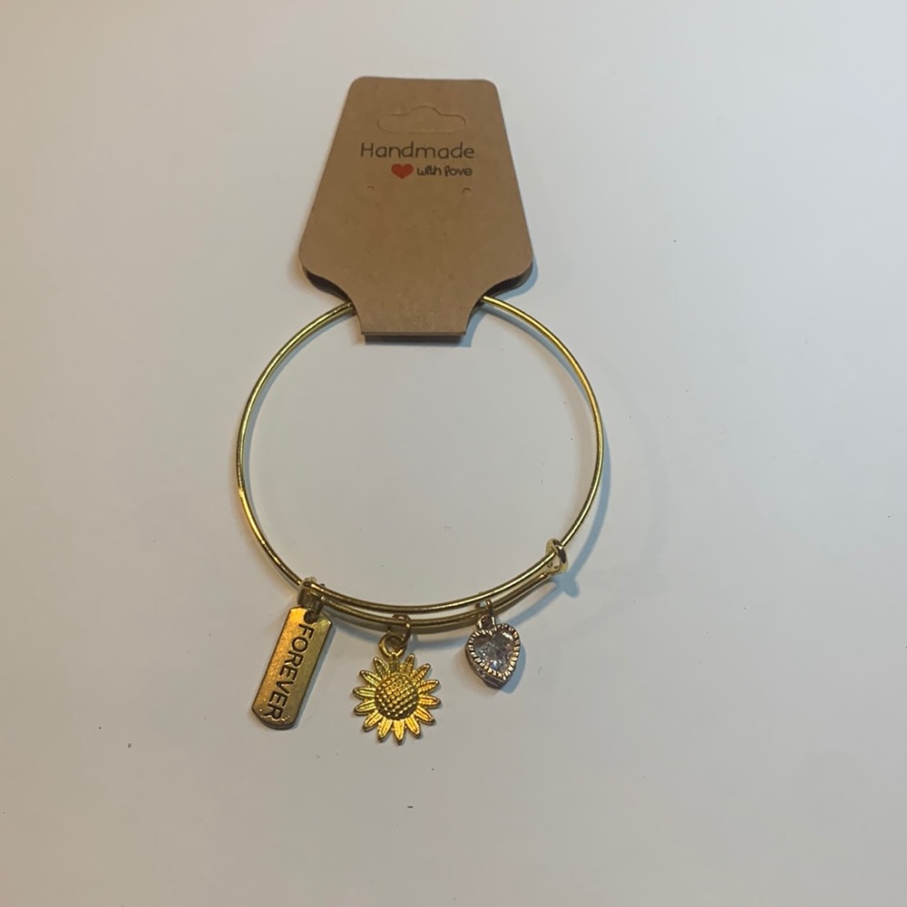 Handmade gold tone stainless steel bracelet with 3 charms.